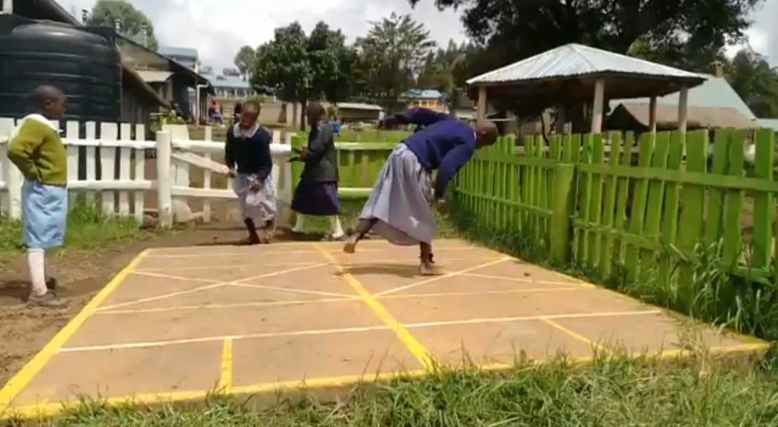 children from Molo orphanage, Kenya, playing on a hopscotch in their outdoor play area