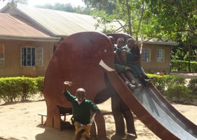 children playing with their new play area at baraa primary school