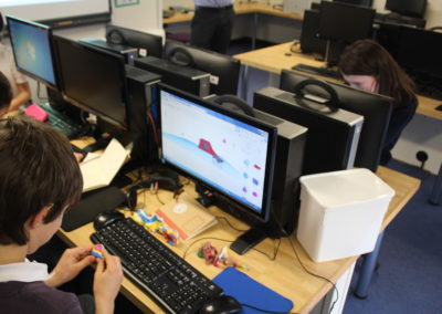 children in a computer suit at school working on their play area designs